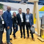 Joseph L. Soliz with four colleagues at the Kapsch TrafficCom exhibit booth