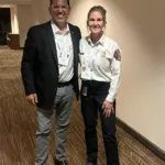 Joseph L. Soliz with a fire service officer in dress uniform at SAE 2025