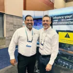 Joseph L. Soliz with a colleague at a connected vehicle technology booth